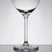 A close-up of a Libbey wine glass with a white rim.