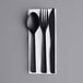 A black Eco-Products 6" wrapped cutlery set with a napkin.
