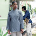 A woman wearing a Uncommon Chef Orleans long sleeve chef coat standing in front of a food truck.