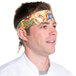 A man wearing an Intedge Coffee & Tea patterned chef bandana.