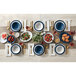 A table set with American Metalcraft Jane Casual linen melamine plates and bowls on a table with food and white flowers.