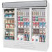 A white Beverage-Air refrigerator with glass doors filled with various types of beverages.