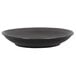 A black plate with a white background and a thin rim with a striped pattern.