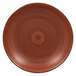 A brown porcelain plate with a circular pattern and black center spiral.