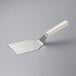 A Dexter-Russell Hamburger Turner with a white rectangular handle.