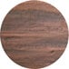 A Lancaster Table & Seating Excalibur round wooden table top with a dark wood finish on a blank background.