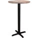 A Lancaster Table & Seating Excalibur round bar height table with a black cross base.