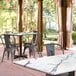 A Lancaster Table & Seating rectangular dining table with a white marble top on a patio.