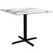 A white Lancaster Table & Seating Excalibur square dining table with a black base.