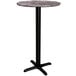 A Lancaster Table & Seating round bar table with a Paladina finish and black cross base.