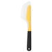 An OXO white and yellow spatula with black accents.