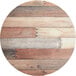 A Lancaster Table & Seating Excalibur round wood table with textured mixed plank finish.