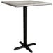 A Lancaster Table & Seating square counter height table with a textured gray top and black cross base.