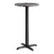 A round bar height table with a smooth dark finish and a black cross base plate.