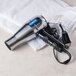 A Conair salon-style hair dryer on a towel.