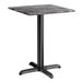 A square standard height table with a smooth dark finish and a black cross base plate.