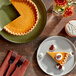 A slice of pumpkin pie on a plate with a fork.