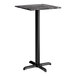 A square bar height table with a smooth dark finish and a black cross base plate.