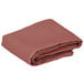 A folded mauve Intedge square table cover.