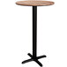 A round brown table top with a black base plate and pole.