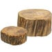 A pair of round wooden logs with different sizes and shapes on a table.