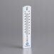 A Comark wall thermometer with a white background and blue numbers.