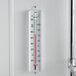 A Taylor dry storage wall thermometer on a white wall.