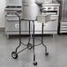 A Hobart 6115-PSTAND portable stand with a large silver container on it.