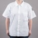 A person wearing a white Chef Revival cook shirt.