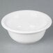 A Tuxton white china pot pie bowl on a gray surface.