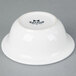 A white Tuxton china bowl with black text that says "Tuxton"