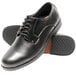 A pair of black leather Genuine Grip oxford shoes with rubber soles.