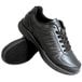 A pair of Genuine Grip black leather athletic shoes with laces.