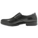 A black slip-on men's dress shoe with a rubber sole.