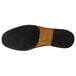 The brown sole of a Genuine Grip black slip-on dress shoe.