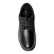 A close-up of a Genuine Grip black leather oxford shoe with laces.