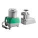 A combination food processor with a gray plastic bowl, continuous feed attachment, and green base.
