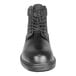 A close-up of a Genuine Grip black leather boot with laces.