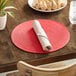 A table set with a RITZ cherry placemat and a plate of food.