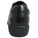 A Genuine Grip black leather shoe with a sole and a heel on a white background.