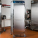 An Alto-Shaam Dutch door holding cabinet with a stainless steel exterior and black handle.