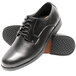 A close-up of a black Genuine Grip men's oxford shoe with rubber soles.