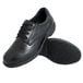 A pair of Genuine Grip black leather shoes with laces and black rubber soles.