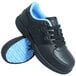 A pair of black Genuine Grip composite toe athletic shoes.