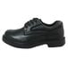 A close up of a Genuine Grip black leather Oxford shoe with laces and a rubber sole.
