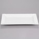 A white rectangular porcelain platter with a scalloped edge.