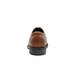 The back of a brown leather Shoes For Crews Senator dress shoe with a black sole.