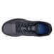 A close up of a black Shoes For Crews Evolution II men's athletic shoe with blue on the sole.