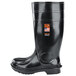 A black rubber Shoes For Crews Guardian IV work boot with an orange logo on it.