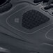 A close up of a black Shoes For Crews Evolution II men's athletic shoe on a table.